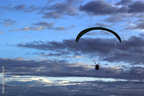 silhouette of paragliding on beautiful sky background