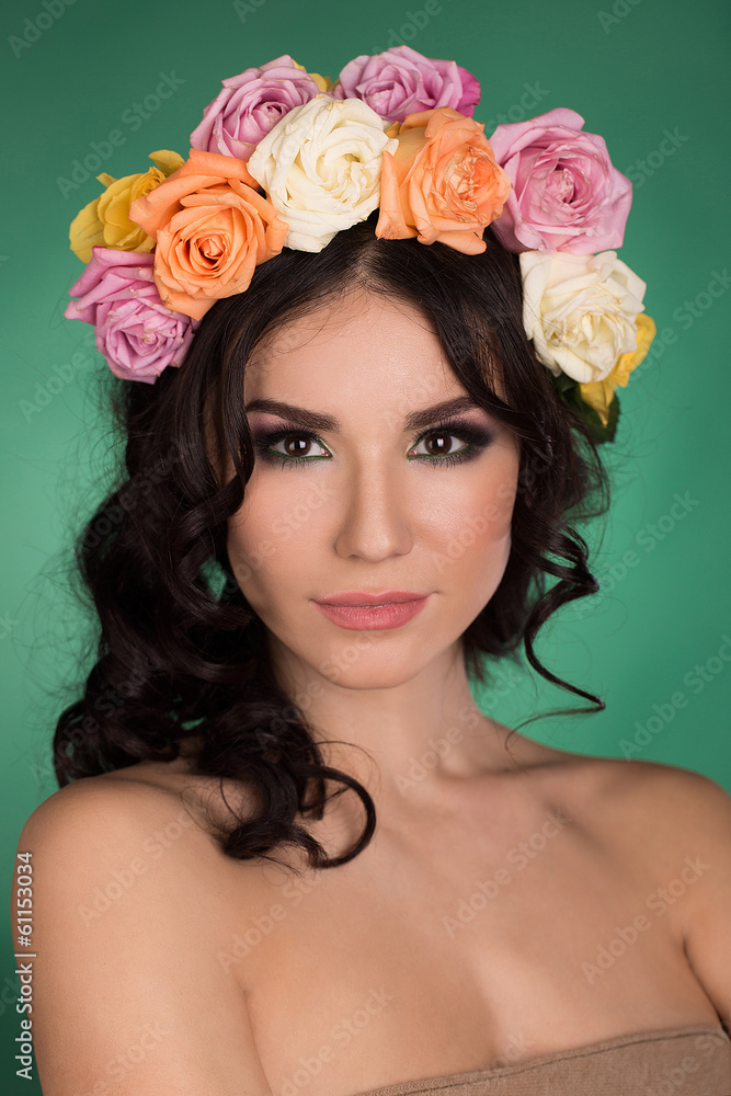 Beautiful young woman with flower wreath. Fashion shot. Portrait