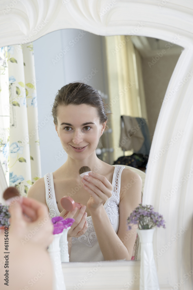 Portrait of a young woman at the mirror Portrait of a young woman at the mirror