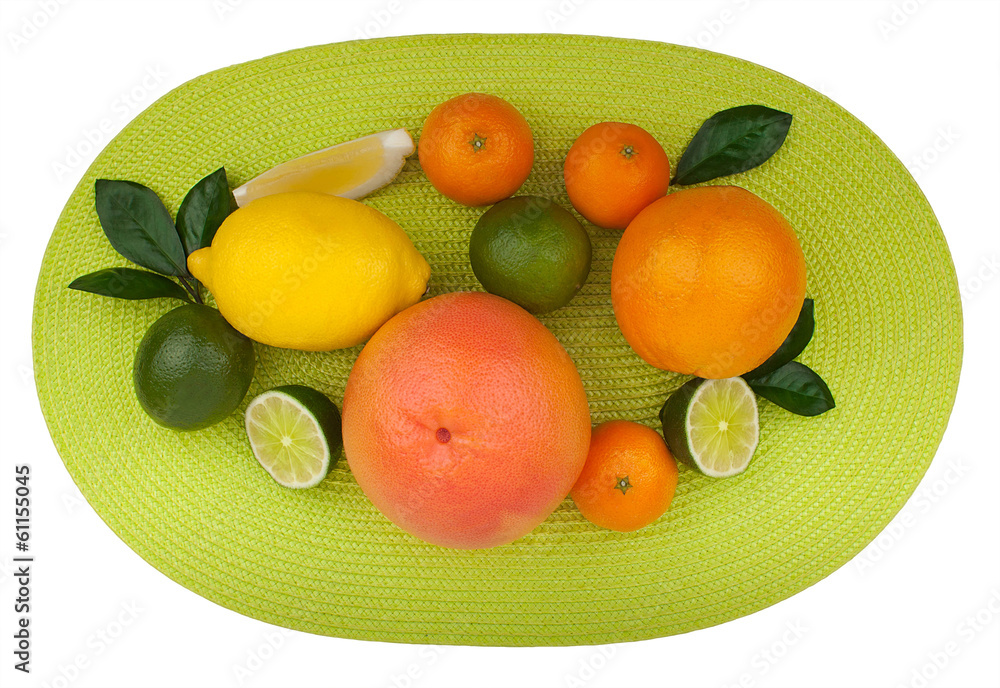 Citrus fruits on green table napkin isolated on white background Citrus fruits on green table napkin isolated on white background