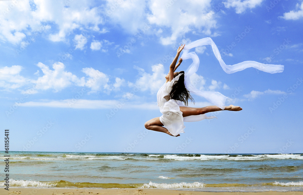 Beautiful girl with white scarf jumping on the beach Beautiful girl with white scarf jumping on the beach