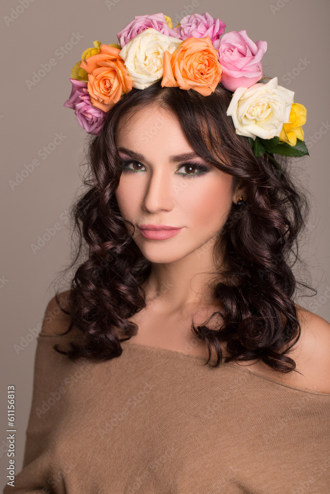 studio portrait of a beautiful woman with wreath