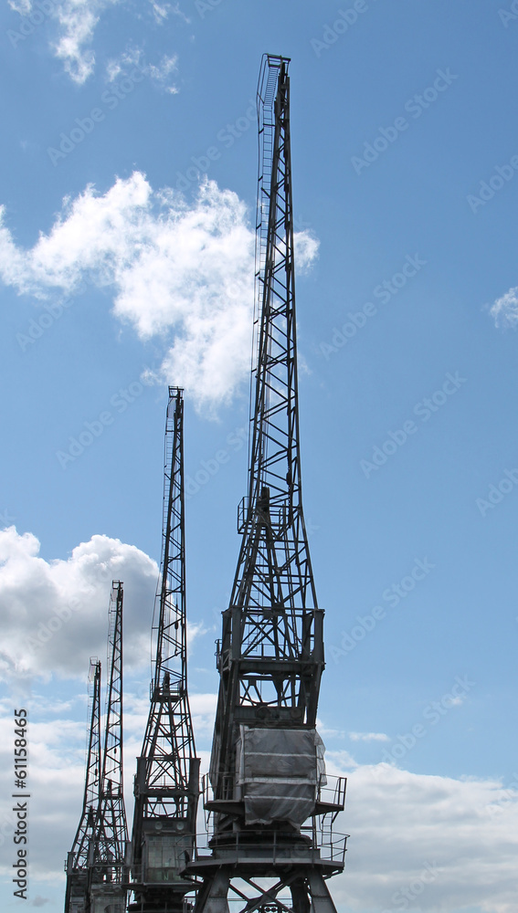 A Row of Traditional Dockside Cargo Cranes. A Row of Traditional Dockside Cargo Cranes.