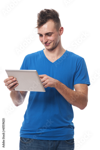 Happy young man using digital tablet