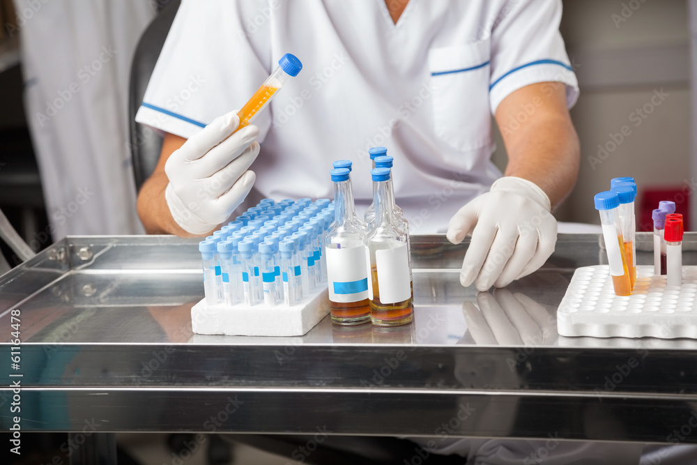 Researcher Analyzing Sample In Test Tube Researcher Analyzing Sample In Test Tube