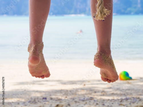 Legs of young girl on the beach