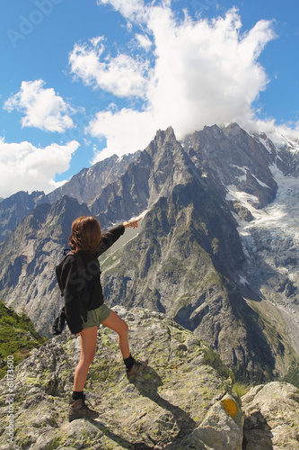 Hiker woman shows Mont Blanc glacier