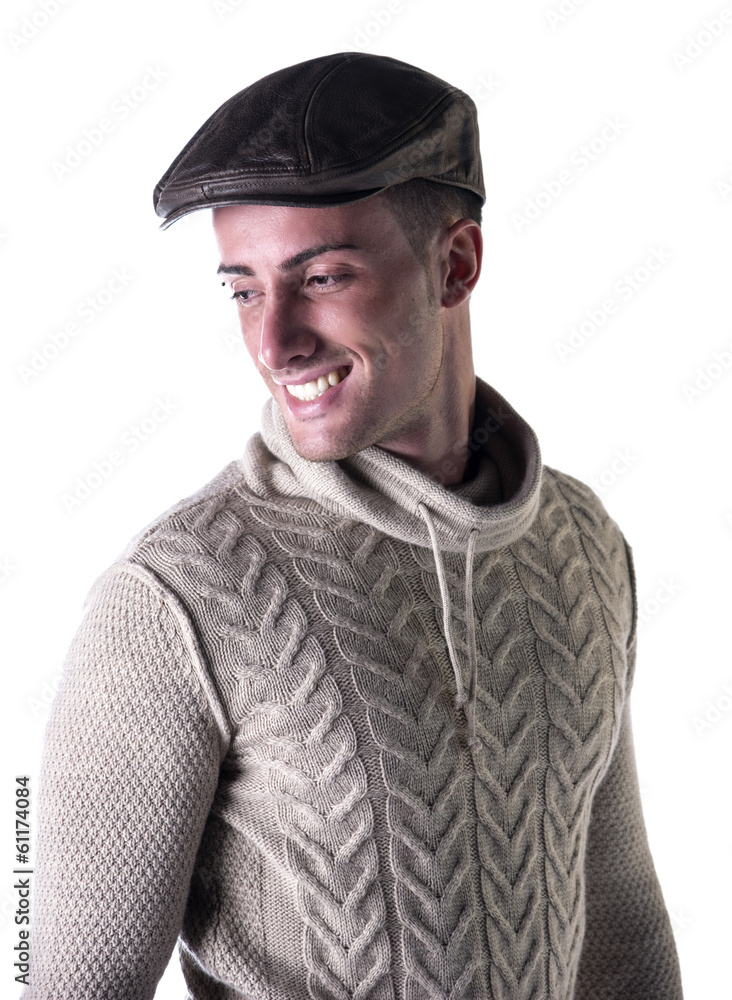 Handsome young man smiling, wearing knitted wool sweater and hat Handsome young man smiling, wearing knitted wool sweater and hat