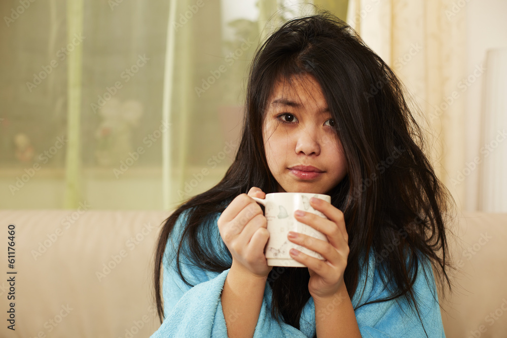 Mädchen und ungemachte Frisur hält Tasse in den Händen Mädchen und ungemachte Frisur hält Tasse in den Händen