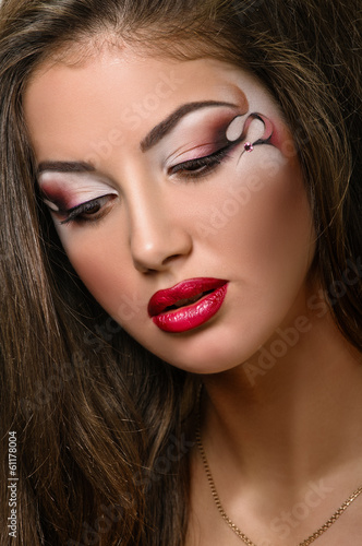face of young woman with makeup close