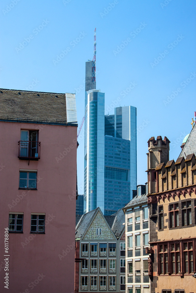 Fototapeta premium Contrast of old buildings and a skyscraper in Frankfurt, Germany
