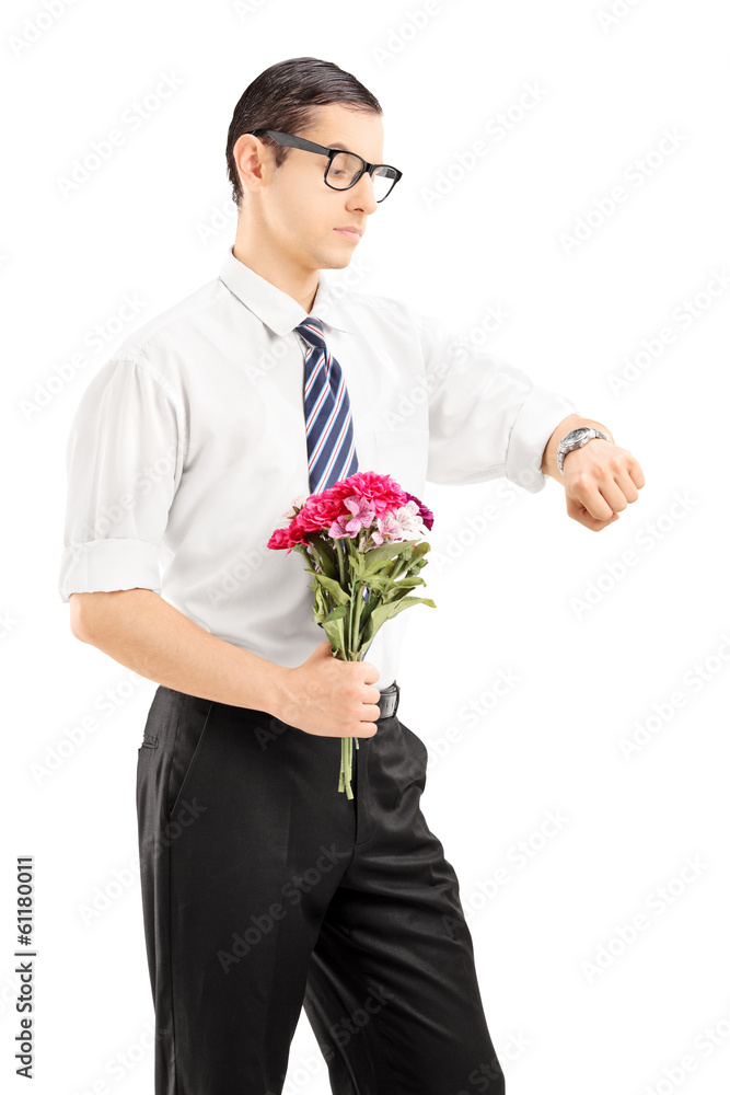 Young man with a bouquet of flowers checking the time Young man with a bouquet of flowers checking the time