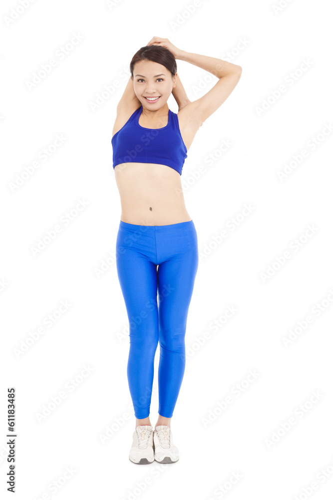 Beautiful fit woman stretching her arm and smiling Beautiful fit woman stretching her arm and smiling
