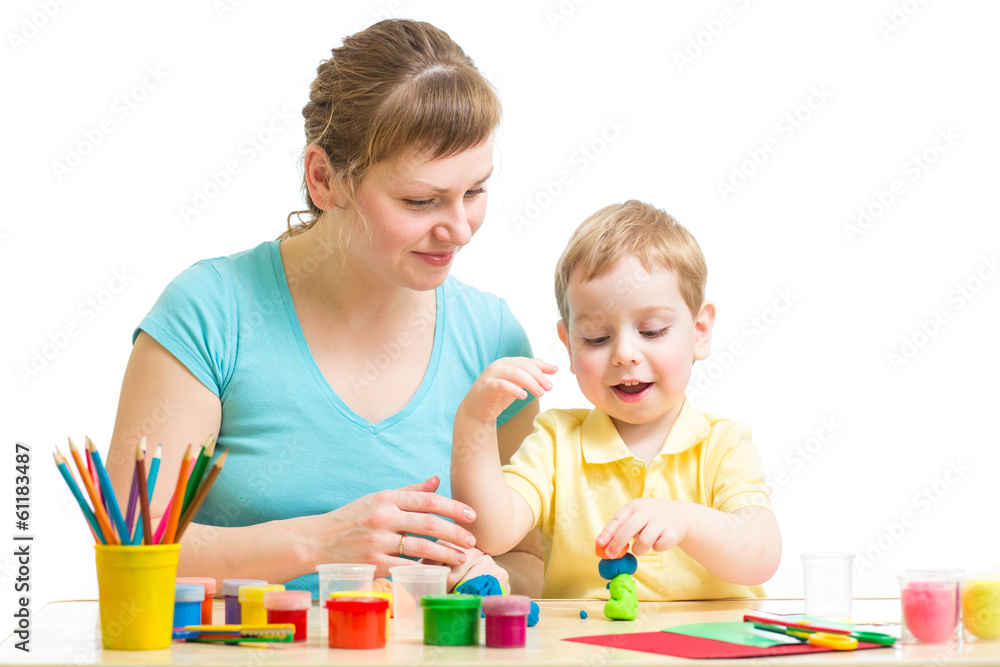 Parent and child plasticine modeling together isolated on white Parent and child plasticine modeling together isolated on white