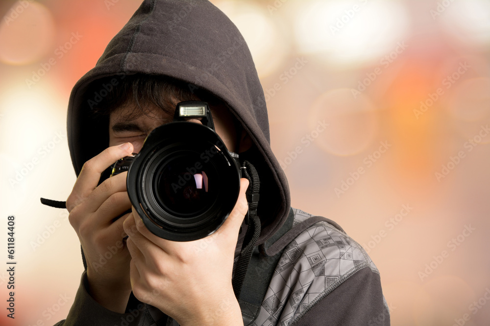 Portrait of young man photographer with camera