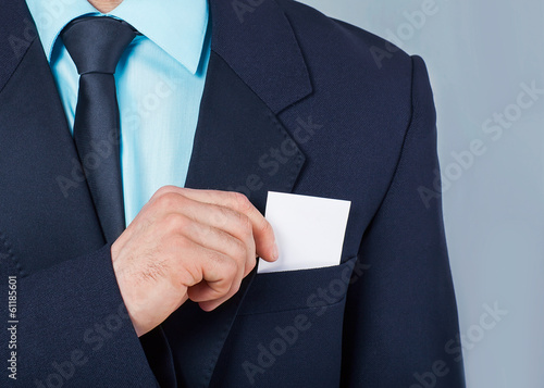 Part of body of business man who takes out business card 