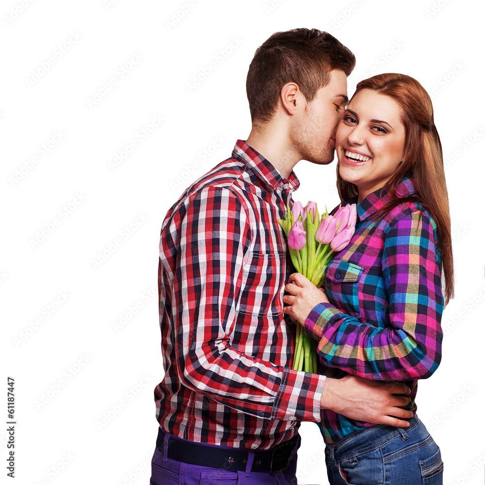 Young couple in love make a heart and hands are holding bouquet Young couple in love make a heart and hands are holding bouquet