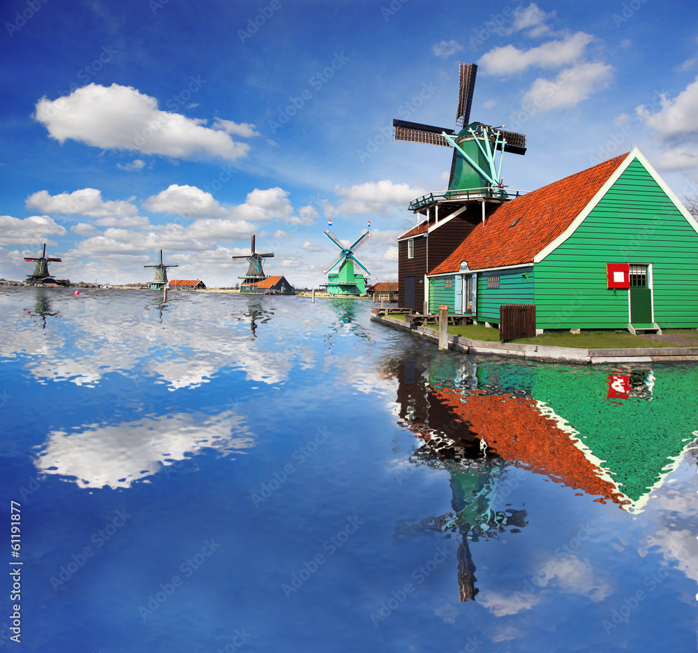 Naklejka premium Windmills with canal in Zaanse Schans, Holland