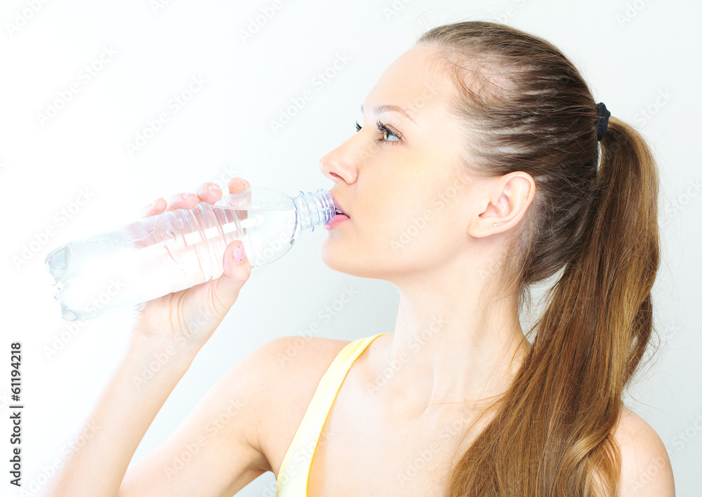 beautiful woman with bottle of water over white beautiful woman with bottle of water over white