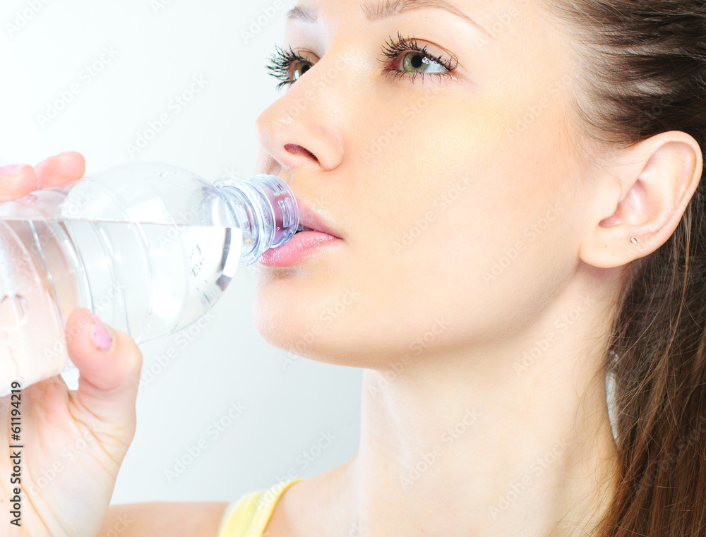 beautiful woman with bottle of water over white beautiful woman with bottle of water over white