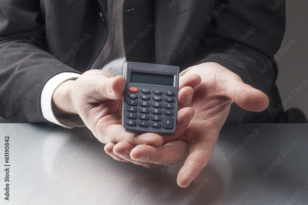 business man displaying a calculator business man displaying a calculator