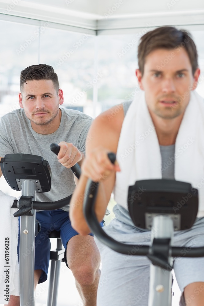 Determined man using exercise bike Determined man using exercise bike