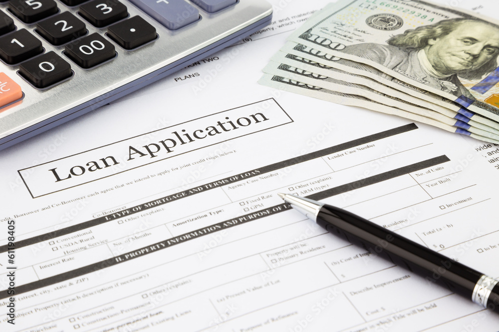 loan application form and dollar banknotes loan application form and dollar banknotes