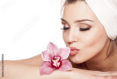 beautiful woman with a towel on her head and kissing orchid