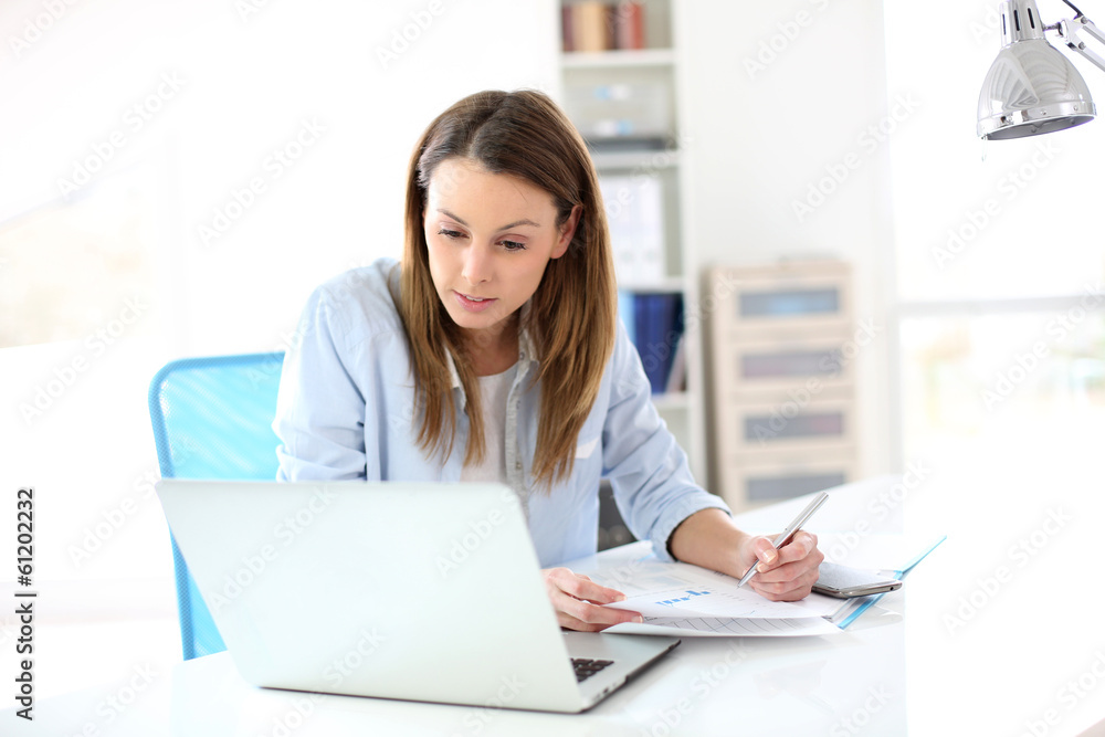 Fototapeta premium Businesswoman working in office on laptop