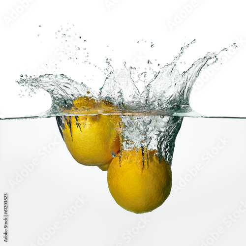 Fresh Lemons Splash in Water Isolated on White Background