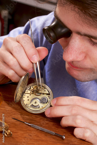 Fényképezés Watchmaker Repairing a Pocket Watch