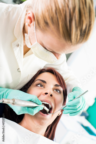 Female dentist with dental drill