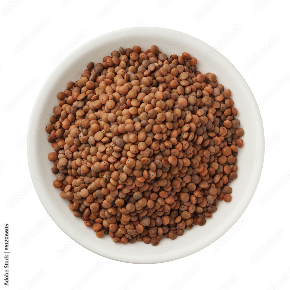 Uncooked lentils in a bowl isolated on white background Uncooked lentils in a bowl isolated on white background