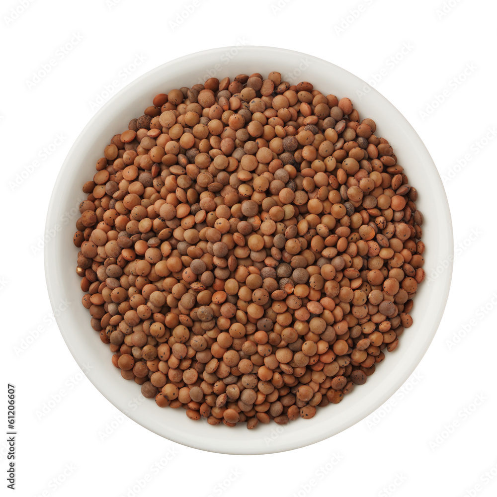 Uncooked lentils in a bowl isolated on white background Uncooked lentils in a bowl isolated on white background