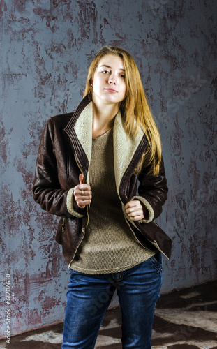 Young girl in leather jacket with fur collar
