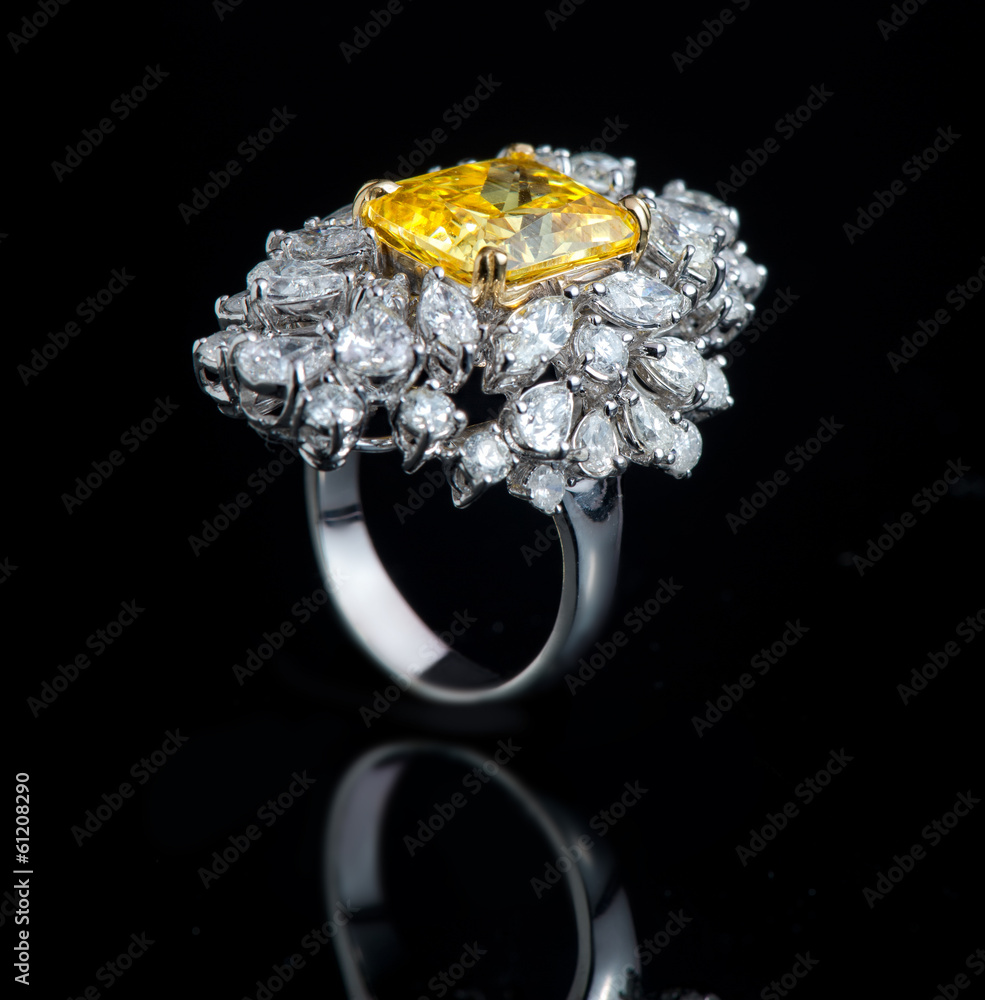 Diamond ring shot on a black reflective background Diamond ring shot on a black reflective background