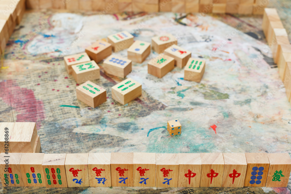 playing in mahjong board game by wooden tiles