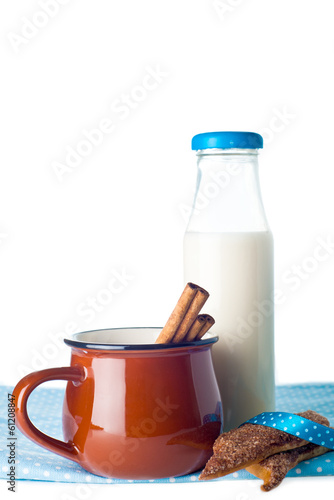 Brown mug, milk, cinnamon and cookies