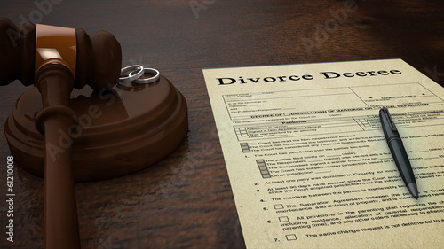 divorce decree paper with a pen, gavel and rings