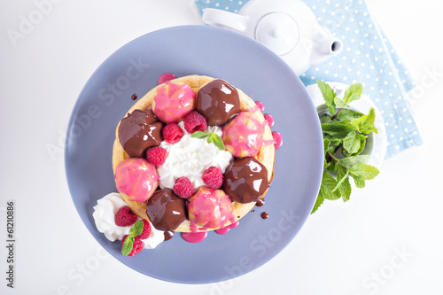 Saint-Honore cake with chocolate and raspberry photo