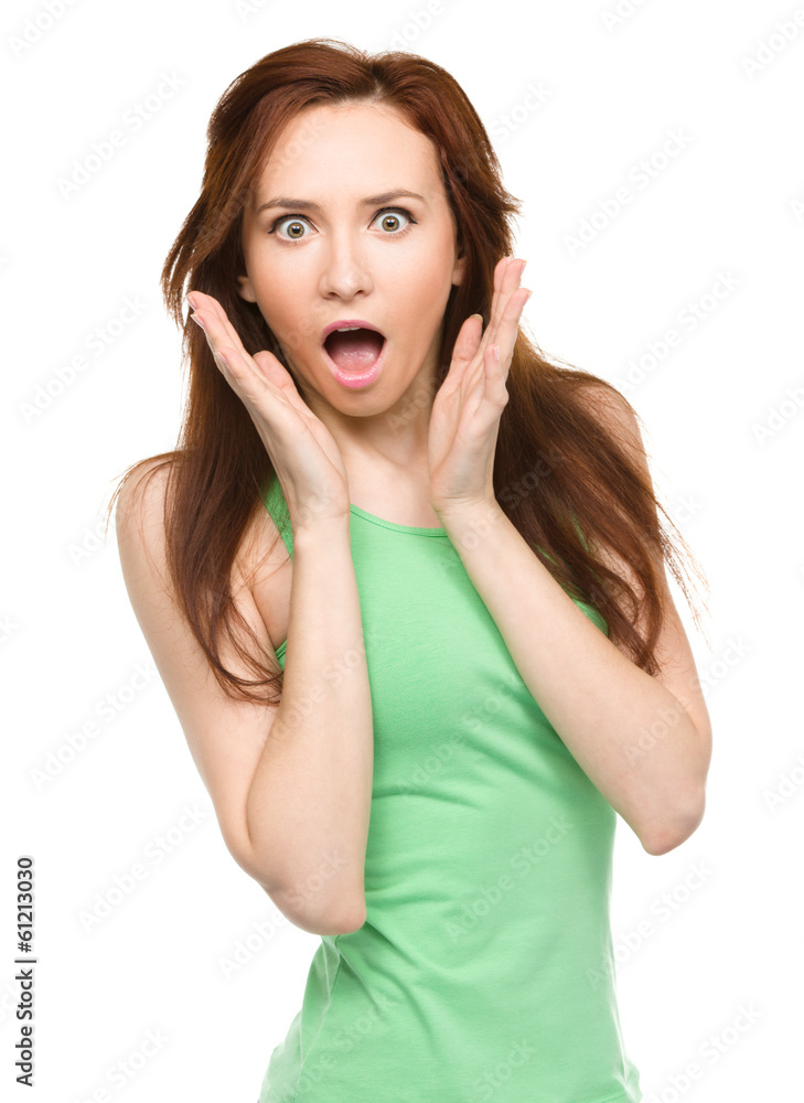 Woman is holding her face in astonishment Woman is holding her face in astonishment