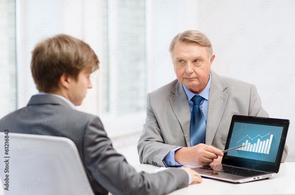 older man and young man with laptop computer older man and young man with laptop computer