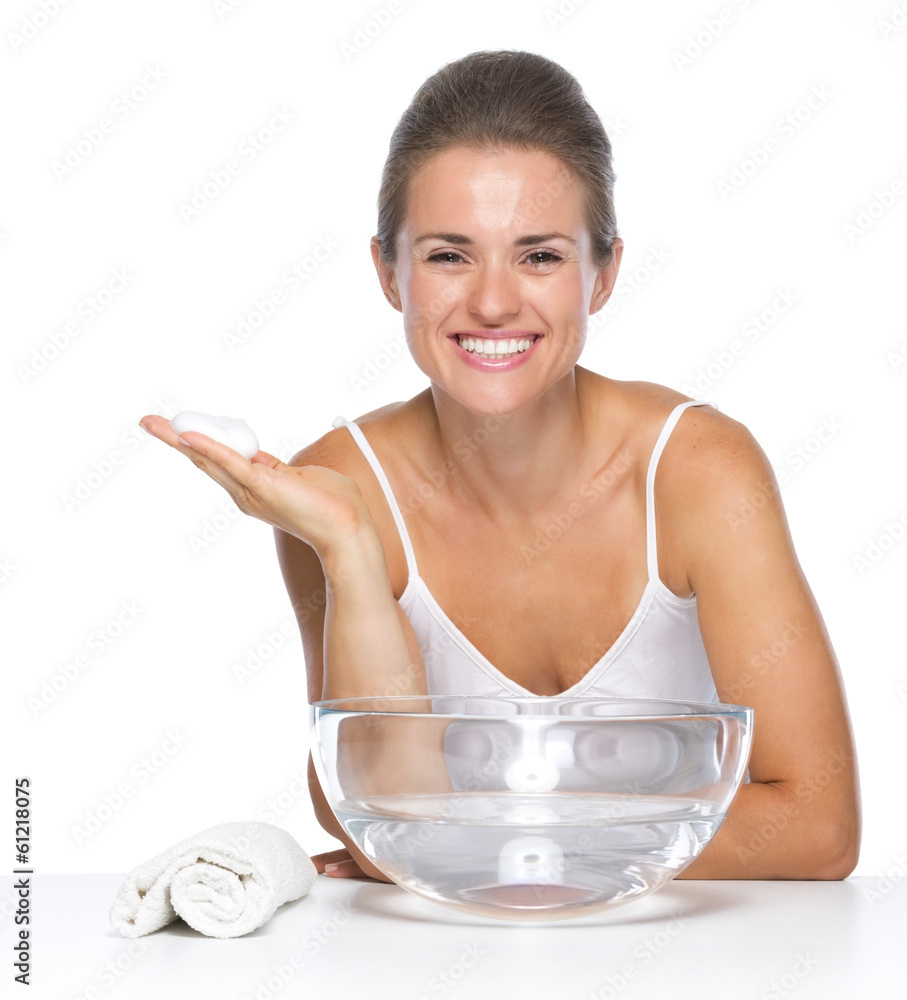 Smiling young woman with soap foam on hand Smiling young woman with soap foam on hand