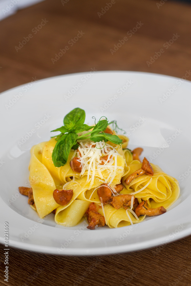 Image of pasta with chanterelle served in white dish