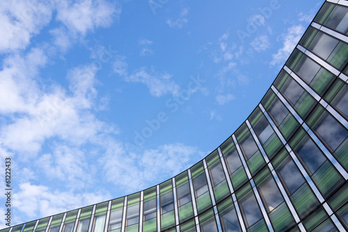 Angled shot of an office building with shiny blue glass