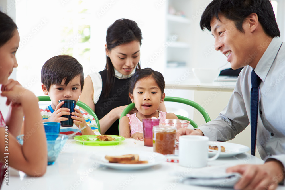 Asian Family Having Breakfast Before Husband Goes To Work Asian Family Having Breakfast Before Husband Goes To Work
