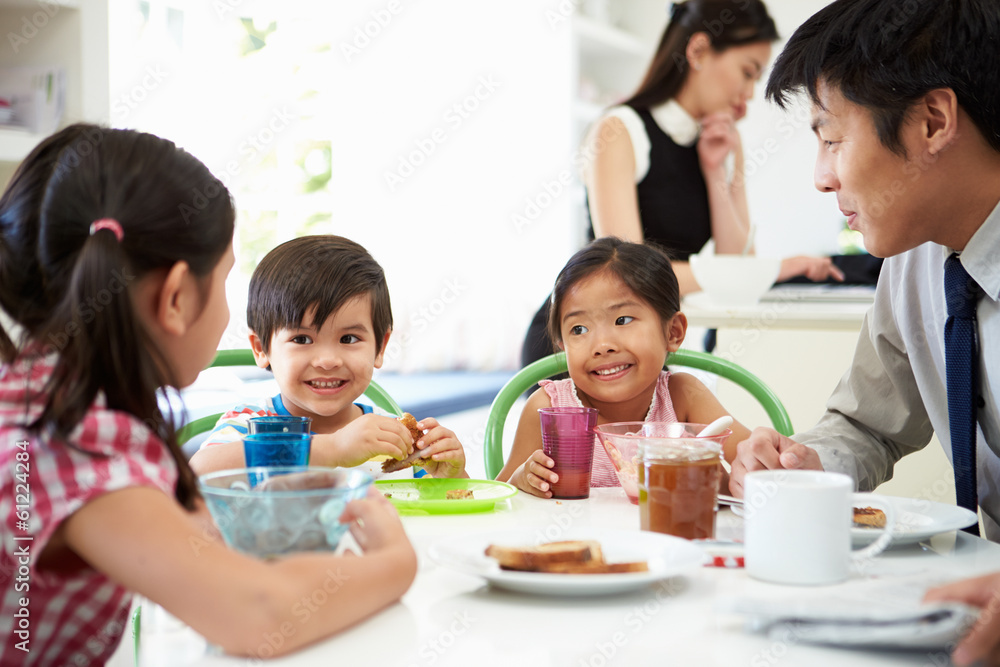 Asian Family Having Breakfast Before Husband Goes To Work Asian Family Having Breakfast Before Husband Goes To Work