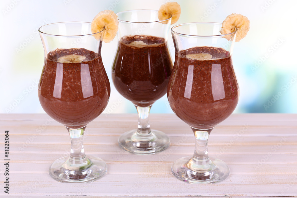 Cocktails with banana and chocolate on table on light Cocktails with banana and chocolate on table on light