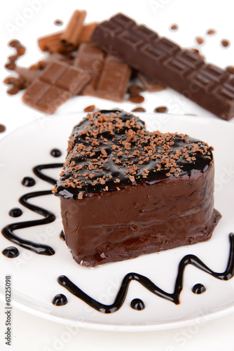 Sweet cake with chocolate on plate close-up