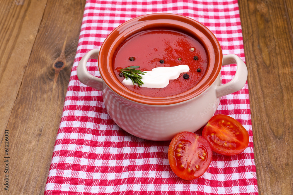 Tasty tomato soup on wooden table Tasty tomato soup on wooden table